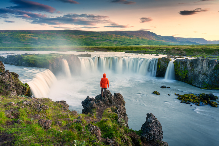 Man standing before waterfall and seeing the power of multi-vendor data enrichment.